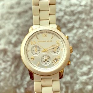 Michael Kors woman’s watch off white, gold trim.